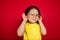 Beautiful emotional little girl isolated on red background. Half-lenght portrait of happy child gesturing