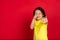 Beautiful emotional little girl isolated on red background. Half-lenght portrait of happy child gesturing