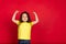 Beautiful emotional little girl  on red background. Half-lenght portrait of happy child gesturing