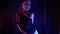 beautiful emotional woman in stage image with bright makeup is dancing in dark room with artistic colored light