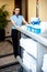 Beautiful employee psuhing housekeeping cart