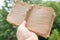 beautiful empty stack of old aged paper torn off edges tied with coarse hemp twine in female hand, sentimental vintage-inspired