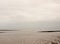 Beautiful empty white grey overcast river with mudflat patterns