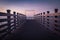 Beautiful empty wooden footbridge pier in koper in colorful purple sunset, slovenia