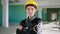 Beautiful engineer woman with a charismatic smile posing in front of the camera at construction site in a sunny day she