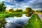 Beautiful English canal and lock gate on calm still day in colourful HDR