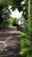 A beautiful English countryside lane with white house and stone wall