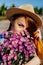 Beautiful enigmatic red hair woman in hat with flowers