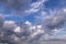 Beautiful epic blue sky with white and grey fluffy cumulus clouds background texture