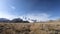 Beautiful epic cinematic view of snow-capped peaks of mountains, field. Autumn