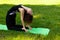 Beautiful European woman in park doing yoga exercises, protects health. Calm and tranquility