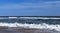 Beautiful evening at the beach with a lone sailboat at a distance - Assateague, MD, USA