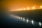 A beautiful evening fog above the river in city centre. Bridge in the mist, autumn scenery. Soft, blurry, misty look. Colorful, my