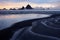 Beautiful evening landscape of sandy iceland beach and dark sharp cliffs