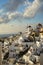 Beautiful evening light scene of Oia white building townscape and windmill along island mountain, Aegean sea, abstract cloud