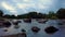 Beautiful evening shot of boulders scattered in the Dalalven river