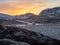 Beautiful evening view drop-off of tourists by car. Icy slippery Arctic road through the tundra