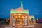 Beautiful example of art deco commercial building at dusk with bright neon signage