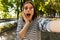 Beautiful excited shocked woman outdoors take a selfie by camera.