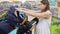 Beautiful expectant mother chooses a stroller in a baby store