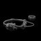 A beautiful, expensive pandora bracelet lies on a table on a black background