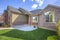 Beautiful exterior of home with brick wall landscaped yard and arched entryway