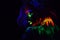 Beautiful extraterrestrial model woman with blue heair and green lips in neon light. It is portrait of beautiful model