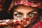 Beautiful eyes. The face of a woman in an red Indian scarf. Expressive look. Oriental beauty