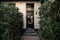 Beautiful facade of the house in thickets of bushes. Black door and surrounding architecture, Holland.