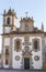 Beautiful facade of medieval church. Old church with cross and bell. Religious architecture in Europe.