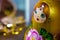 A beautiful face of Matryoshka, traditional Russian babushka doll, stacking doll, nesting doll in gold, green, yellow, pink colors