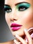 Beautiful Face of a woman with green vivid make-up of eyes