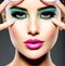 Beautiful Face of a woman with green vivid make-up of eyes