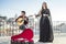 Beautiful fado singer performing with handsome portuguese guitar