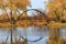 Beautiful fall landscape with a bridge in the city park.