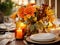 Beautiful fall table setting, autumn dinner table decoration with flowers and candles, holiday event decor in orange and