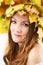 Beautiful fall woman. Portrait of girl with autumn wreath of maple leaves on head on isolated