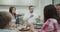 Beautiful family atmosphere on the dinner table shearing the food and eating a health lunch all together.