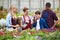 Beautiful family choosing and buying flowers in the greenhouse.