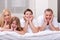 Beautiful family lying on bed smiling