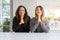 Beautiful family of mother and daughter together at home praying with hands together asking for forgiveness smiling confident