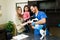 Beautiful family petting their puppy at the vet clinic