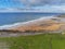 Beautiful Fanore beach, county Clare, Ireland. Aerial view. Blue Atlantic ocean water, yellow sand. People swimming and surfing. C