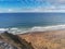 Beautiful Fanore beach, county Clare, Ireland. Aerial view. Blue Atlantic ocean water, yellow sand. People swimming and surfing. C