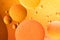 Beautiful and fantastic macro photo of water droplets in oil with a orange background.