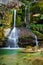 Beautiful fantasy-like waterfall with emerald green water