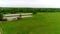 Beautiful farm with a pond outside the city, aerial view