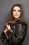 Beautiful fashion model , leather fur clothes. Young woman