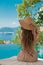 Beautiful Fashion Woman in beach hat enjoying sea view by swimming pool on luxury tropical resort. Exotic Paradise.