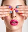 Beautiful fashion woman with a colored nails. Attractive white girl with multicolor manicure